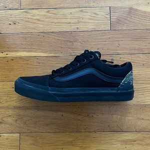 Black Vans with tiger print in the back.